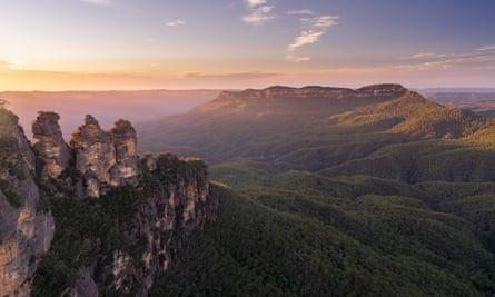 Golden early morning light on Mount Solitary with the famous three sisters in the foreground, Blue Mountains, NSW, Australia